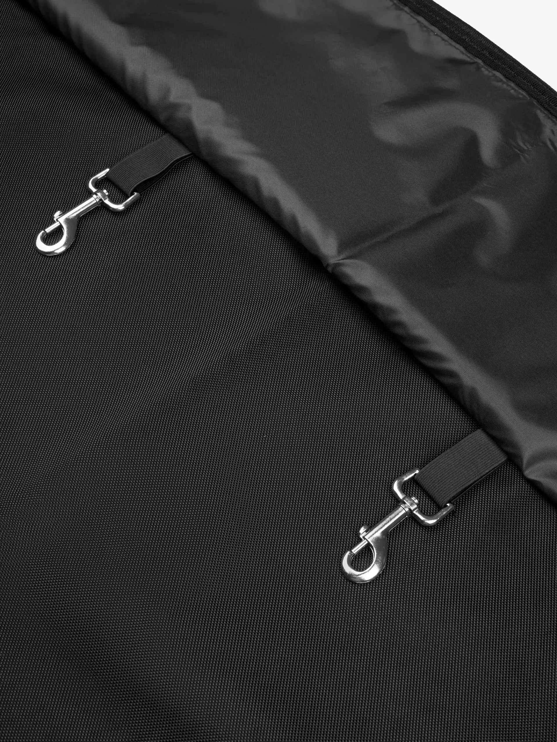 LEMIEUX SHOW STABLE DRAPE BLACK: Close-up view of black fabric with silver clips for secure hanging at horse shows.