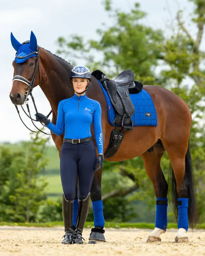 LeMieux Loire Dressage Saddle Pad in Benetton Blue with rider & horse. Stylish equestrian equipment from Equiflair.
