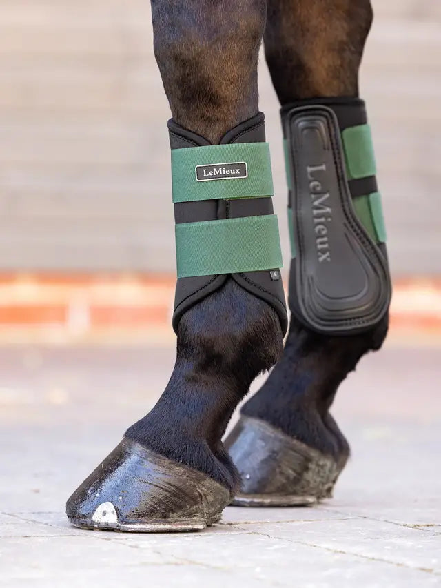 LEMIEUX GRAFTER BRUSHING BOOT HUNTER GREEN on horse legs: Durable equestrian protection by Equiflair.