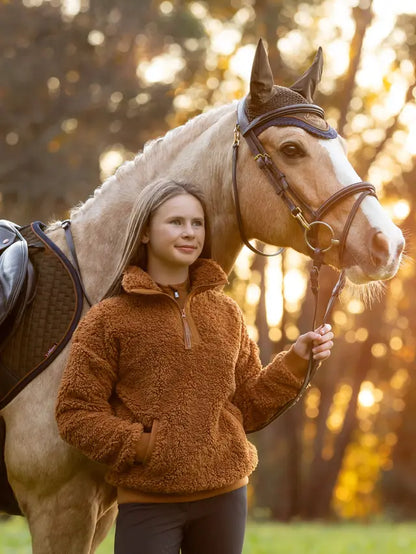 Girl and horse with Lemieux Young Rider Tia Teddy Fleece Ginger for equestrian activities. Comfortable riding attire.
