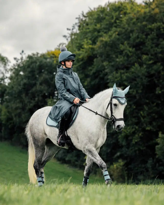 Girl Riding Horse in LEMIEUX Waterproof Coat: Equestrian Style & Protection