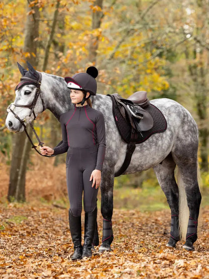 Girl with grey dapple horse in Lemieux Cinder Suede GP Square. Equestrian horse riding gear from Equiflair.