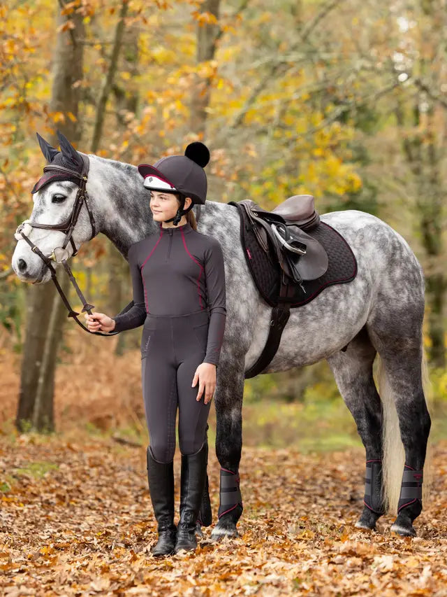 Girl with grey dapple horse in Lemieux Cinder Suede GP Square. Equestrian horse riding gear from Equiflair.