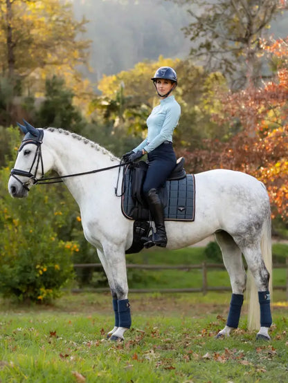 Equestrian Elegance: Woman on Horse with LeMieux Loire Classic Dressage Saddle Pad in Petrol