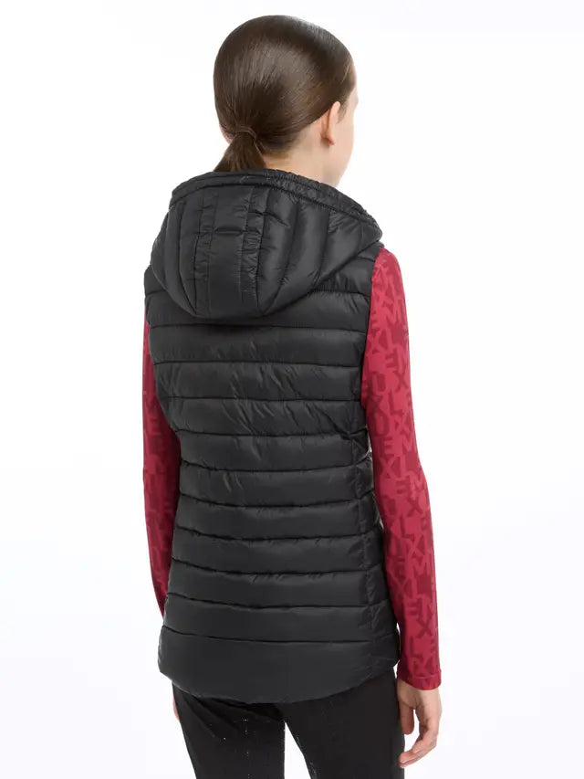 Lemieux Young Rider Milly Black Puffer Gilet with Hood. Girl wearing children's black puffer vest from behind.