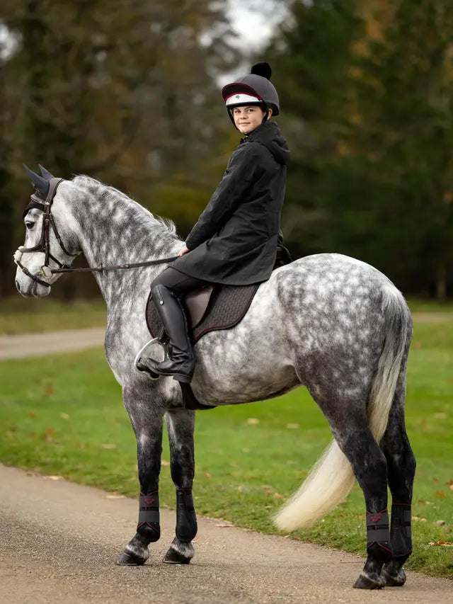 Young Rider in LeMieux Waterproof Coat on Dapple Gray Horse | Equiflair Equestrian Apparel