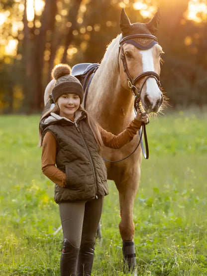 Young Girl with Horse wearing LeMieux Reversible Winter Gilet - Equestrian Fashion