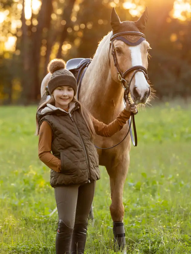 Young Girl with Horse wearing LeMieux Reversible Winter Gilet - Equestrian Fashion