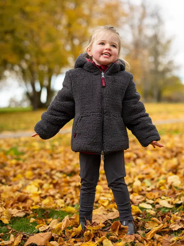 Girl in LeMieux Mini Megan Reversible Puffer Coat Ember - Fall Fashion, Kid's Winter Outerwear - Equiflair
