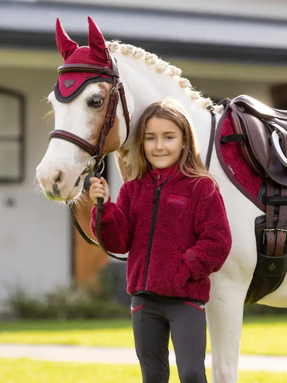 Girl & Horse in Matching Burgundy LeMieux Riding Gear. LeMieux Mini Teagan Fleece Jacket. Equestrian Fashion for Kids, Equiflair.