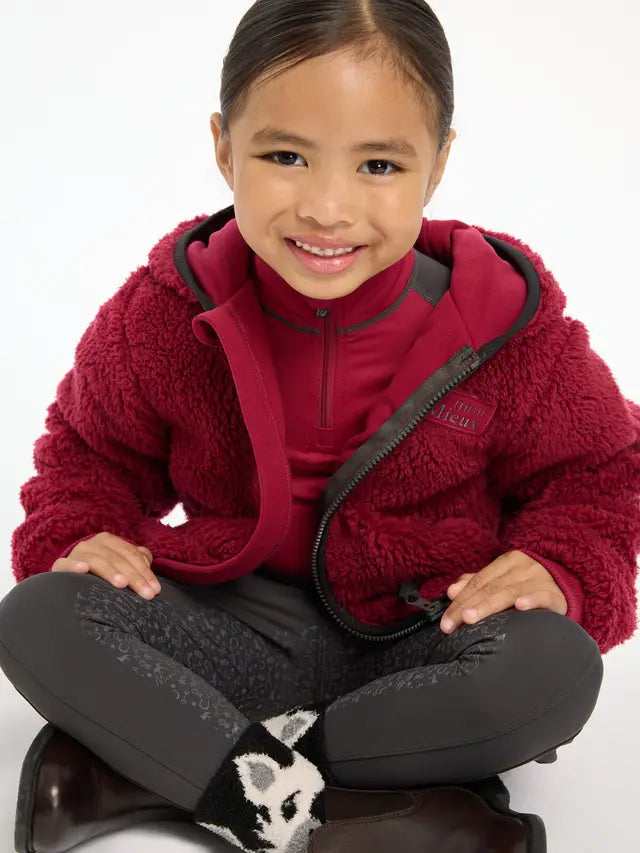 LeMieux Mini Teagan Fleece Ember - Girl wearing kids fleece jacket for winter warmth and style. Equiflair