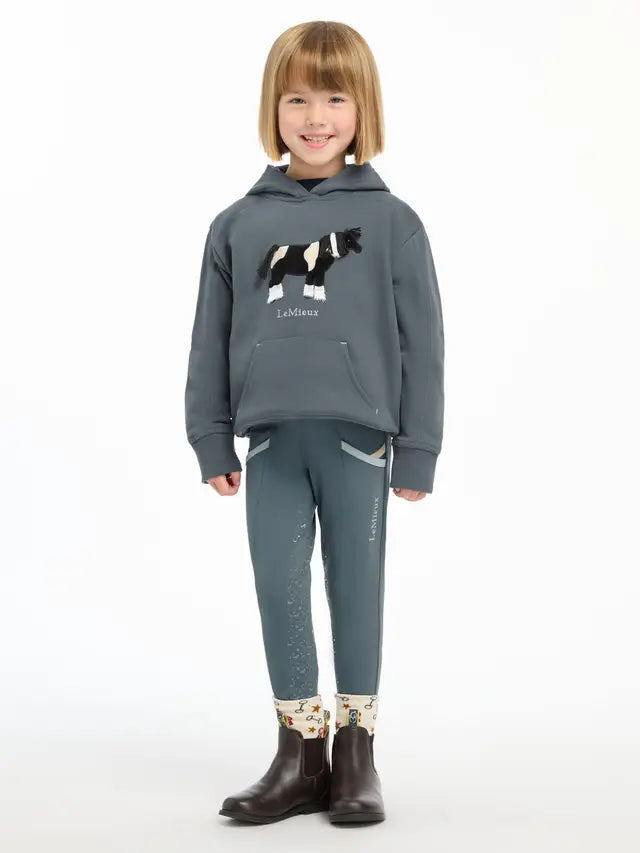LEMIEUX MINI ROMI HOODIE Petrol: Girl wearing hoodie with horse appliqué. Equiflair.