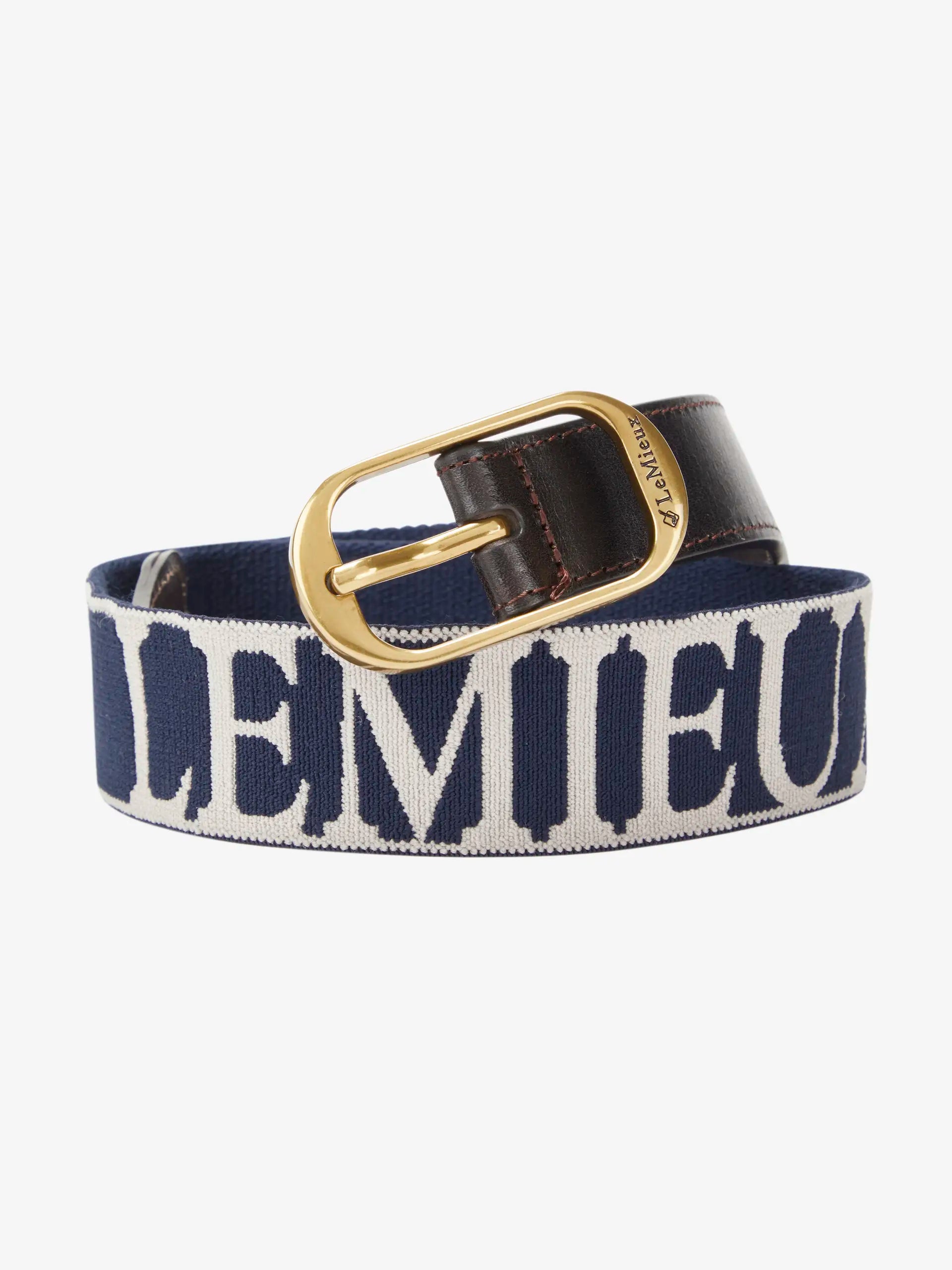 LeMieux Eddie Elasticated Belt Navy/Stone. Equestrian belt, horse riding accessory, navy belt with white Lemieux logo and brass buckle.