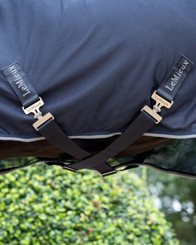 LEMIEUX Kudos Hybrid Cooler Navy Horse Rug: Close-up of surcingle straps with LEMIEUX branding.