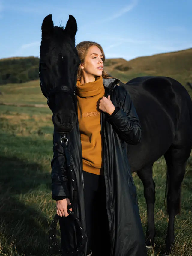 LeMieux All Elements Black Waterproof Coat. Woman with horse. Equestrian Clothing. Available at Equiflair