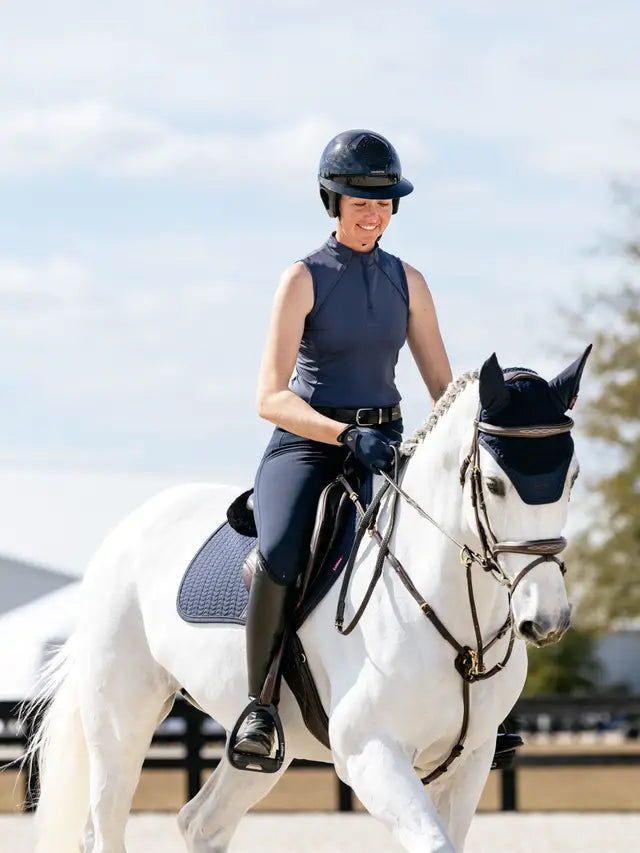 Equestrian Style: Woman Riding Horse in Lemieux Maria Mesh Sleeveless Baselayer Dusk Blue - Equiflair