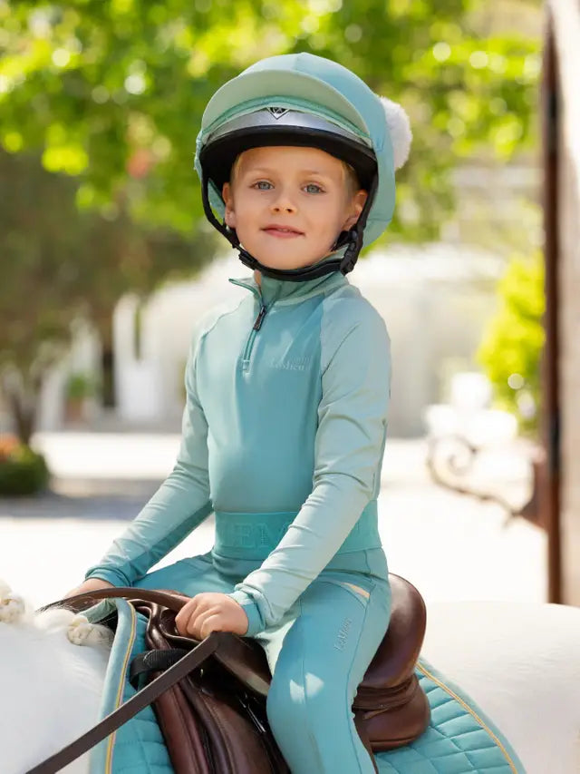 Child Horse Rider in LeMieux Lagoon Helmet with Pom Poms | Equiflair
