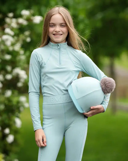 LEMIEUX Pom Hat Silk Aqua/Lagoon at Equiflair: Equestrian riding helmet cover with detachable faux fur pom pom for stylish riders.