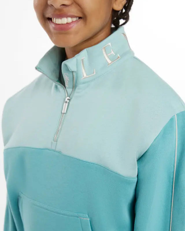 LeMieux Young Rider Kate Quarter Zip Sweat - Lagoon. Stylish, comfortable quarter zip for young equestrians.