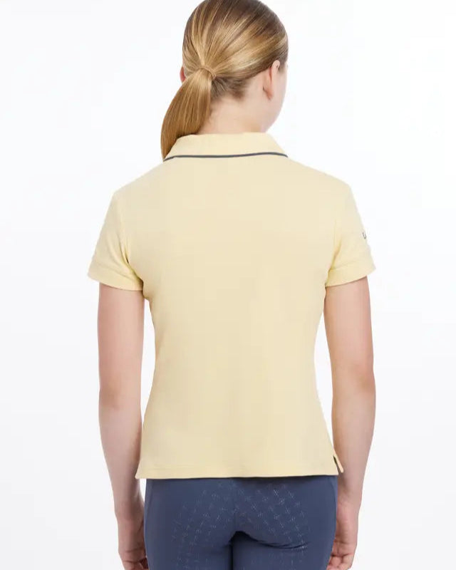 LeMieux Young Rider Polo Shirt Mimosa - Equiflair: Back view of girl in riding polo shirt.