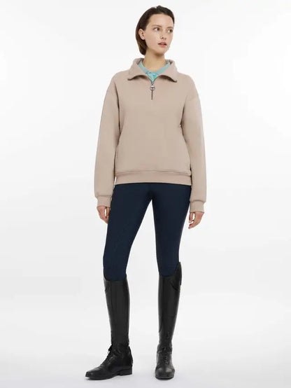 Woman in LeMieux Keira Quarter Neck Sweatshirt Almond - Equiflair Riding Apparel