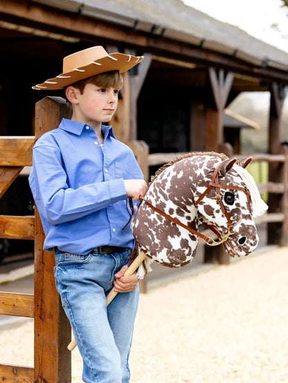 Boy with Lemieux Montana Hobby Horse: Cowboy Fun! Realistic toy horse, perfect for pretend play & imaginative adventures.