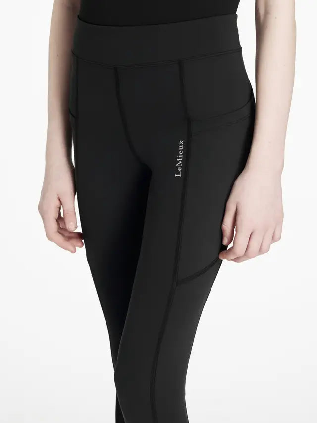 LeMieux Young Rider Darla Sport Leggings - Black. Riding leggings with pockets, seam-free design for comfort and performance.