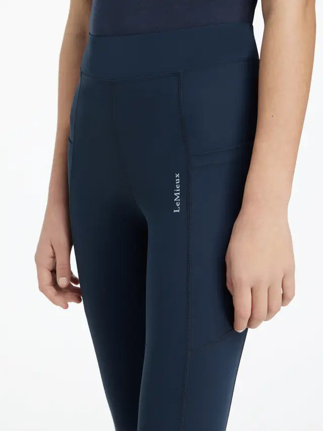 LeMieux Young Rider Darla Sport Legging Navy: Equestrian riding leggings with phone pockets and technical fabric. Comfortable and stylish.