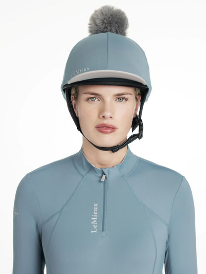 LeMieux Classique Ice Blue Pom Hat Silk: Stylish equestrian helmet cover with detachable faux fur pom pom, available at Equiflair.