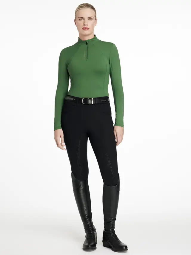 Woman in LeMieux Hunter Green Base Layer, Equestrian Riding Pants & Boots. Stylish Equestrian Apparel by Equiflair Saddlery.