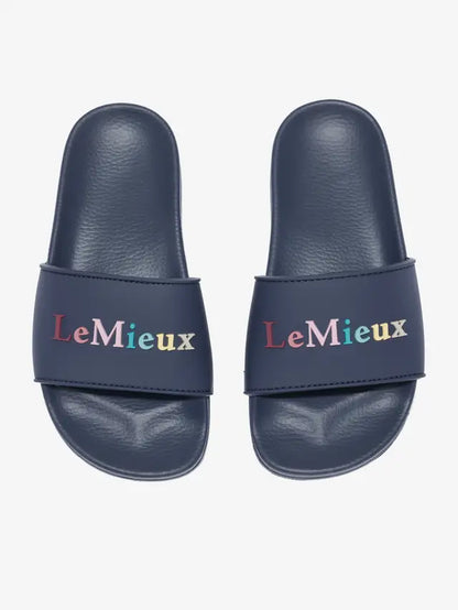 LeMieux Young Rider Sliders Dusk: Comfortable slip-on sandals for kids, featuring colorful logo branding and a supportive footbed.