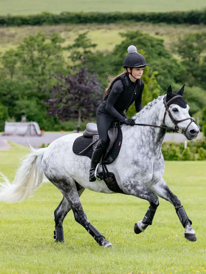 Equestrian Rider on Dapple Gray Horse Wearing LEMIEUX SUEDE GP SQUARE BLACK Saddle Pad from Equiflair, Black Gear Horseback Riding