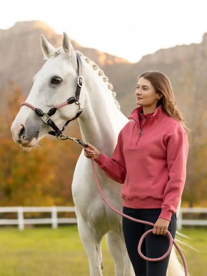 Woman with White Horse Wearing LeMieux Keira Quarter Zip Sweatshirt in Cranberry. Horseback Riding Apparel by Equiflair.