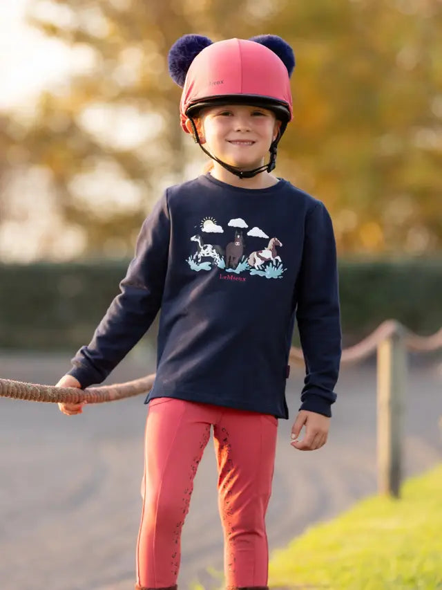 LeMieux Mini Poppy Long Sleeve Top Navy for Kids | Horse Riding Apparel | Girl in Equestrian Outfit & Helmet