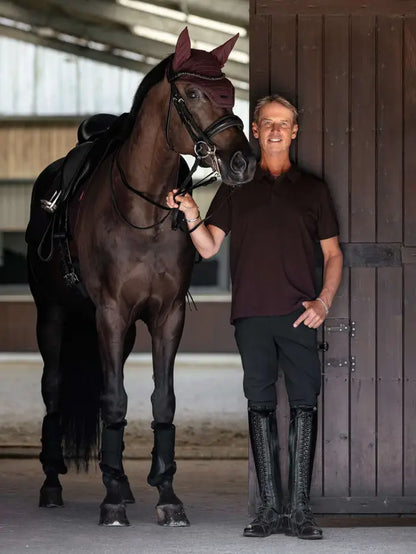 Man in LeMieux polo shirt and riding boots with horse. Equiflair store.