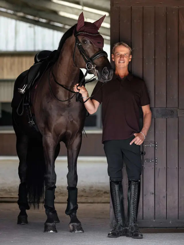 Man in LeMieux polo shirt and riding boots with horse. Equiflair store.