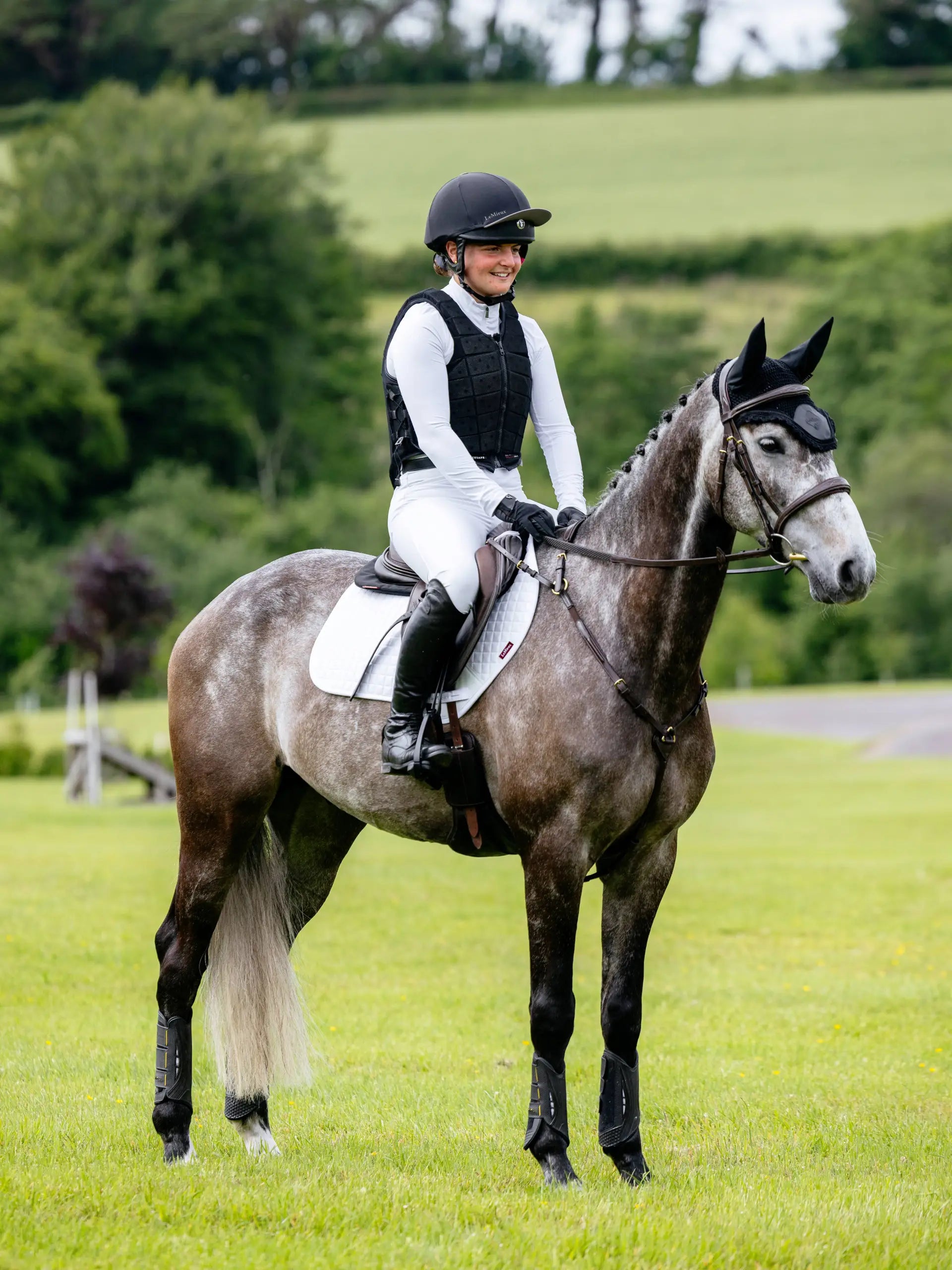 Equestrian: Rider on Grey Horse with White LeMieux Saddle Pad, English Riding Style
