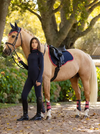 Young girl with palomino horse wearing LeMieux Savannah Navy Snood Base Layer, equestrian riding clothing.