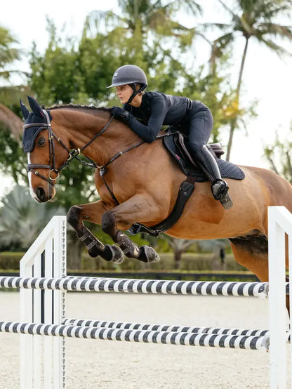 Equestrian show jumping a horse wearing a navy LeMieux Brilliance Close Contact Square saddle pad