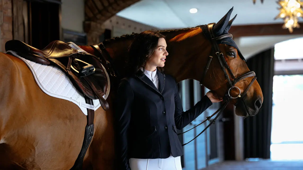 Equestrian rider with horse, featuring a white LeMieux close contact saddle pad with sparkle detailing.