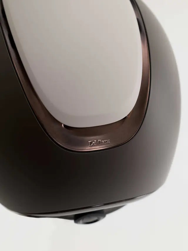 Close-up of LeMieux logo on a Matte Stone equestrian riding helmet