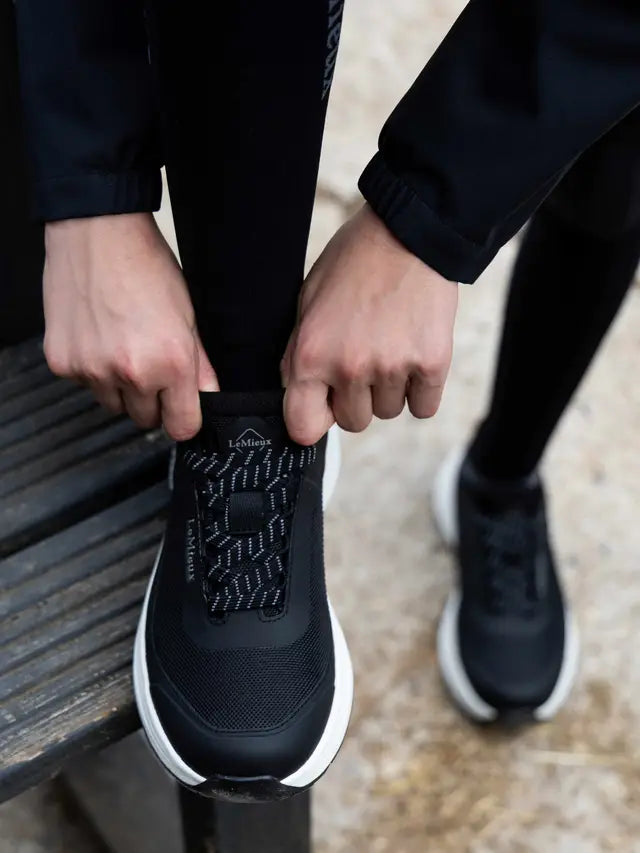 LeMieux Junior Kanta Waterproof Trainers Black being tied, equestrian shoes with grip