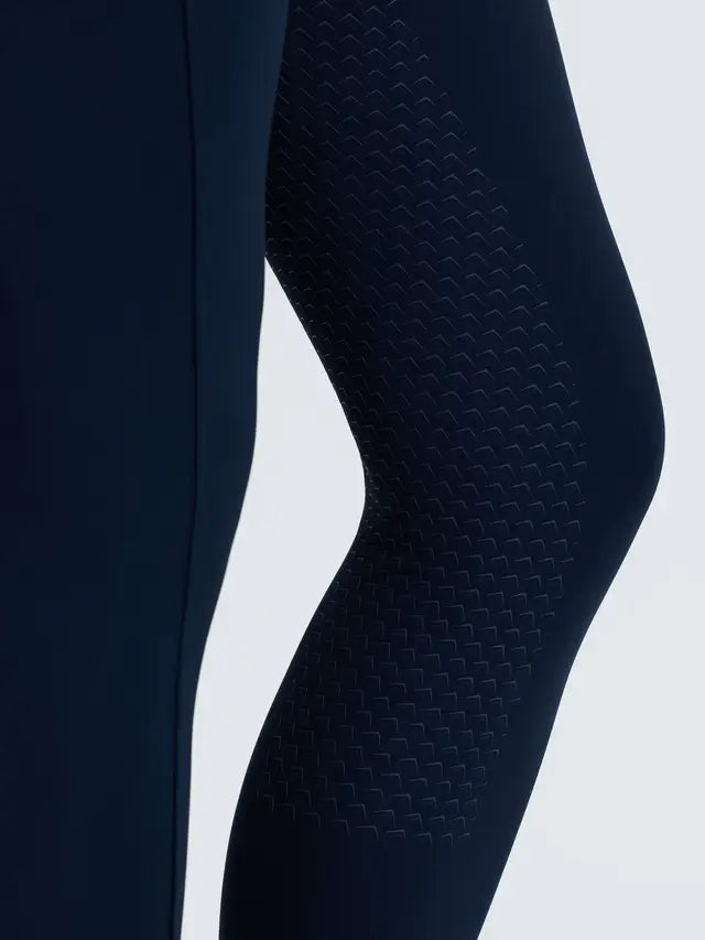 Navy LeMieux riding leggings with patterned silicone full seat detail and brushed fabric.