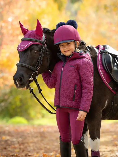 LeMieux Mini Lola Quilted Jacket Blackberry worn by a girl with a pony in autumn
