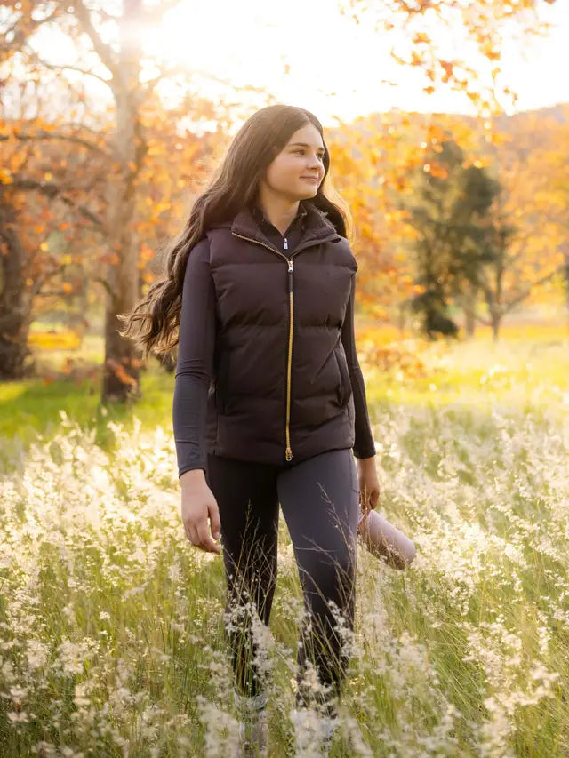 LeMieux Young Rider Joey Hooded Puffer Gilet in Cocoa - Autumn outdoor shot