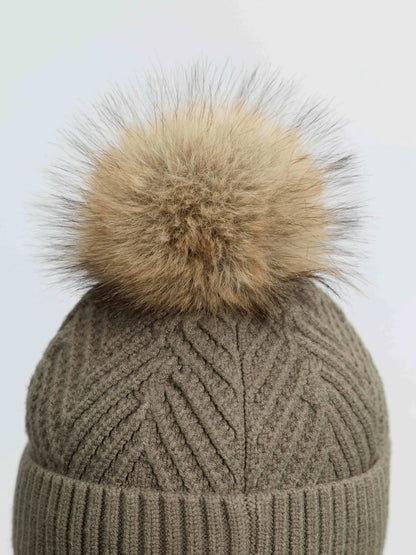 LeMieux Clara Knit Beanie in Willow Green with a fluffy fur pom pom, close-up view.