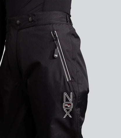 PREMIER EQUINE NOX DUO Waterproof Trousers Black. Equestrian riding apparel with gel seat, zippered pockets, reflective detailing.