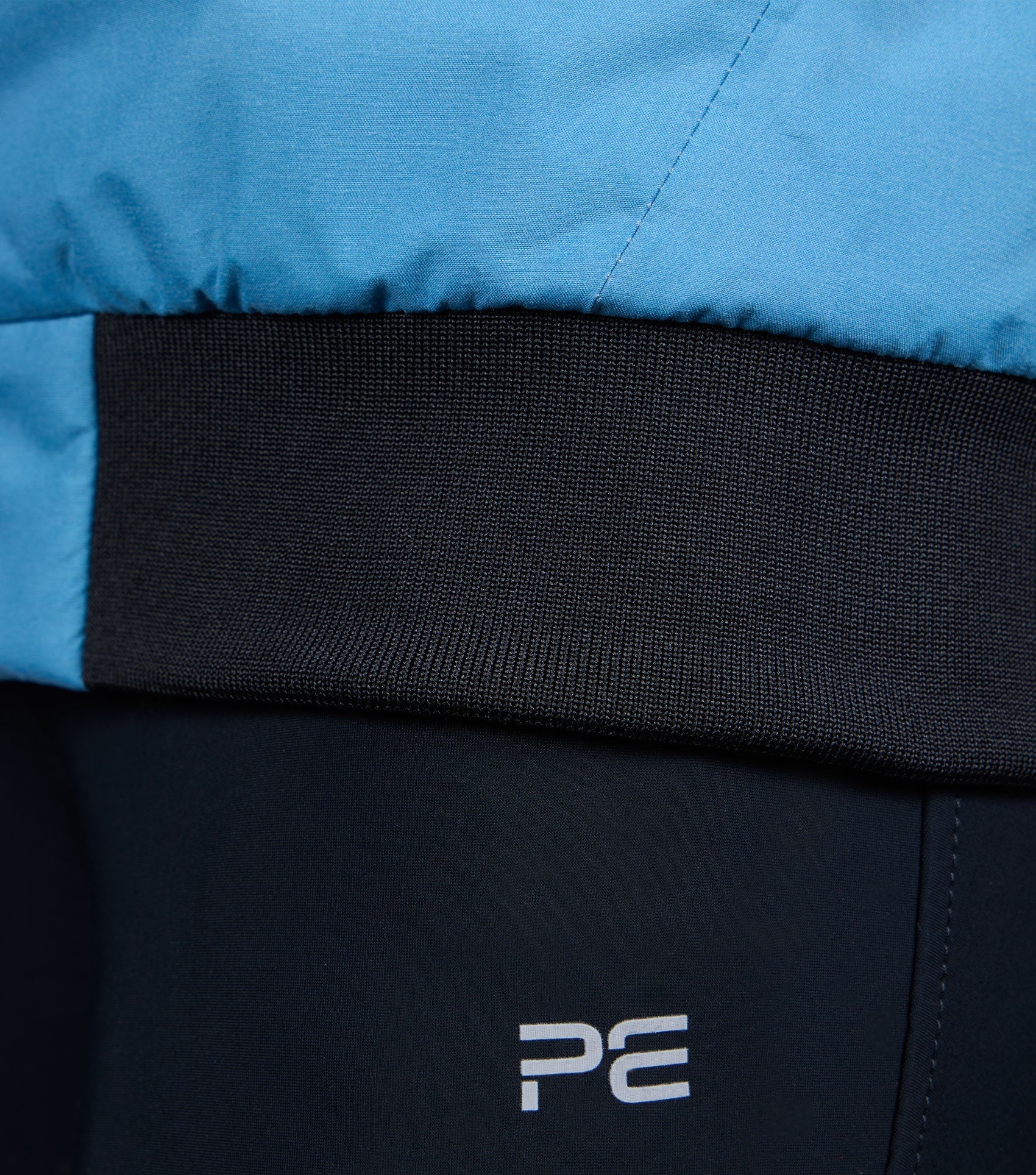 Premier Equine Omnia Women's Riding Jacket Azure Blue Detail: Collar, Waistband, and PE Logo