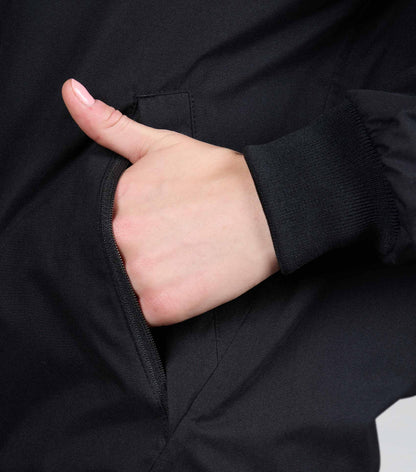 Premier Equine Omnia Waterproof Riding Jacket Black: Close-up of hand in pocket, showing quality & design.