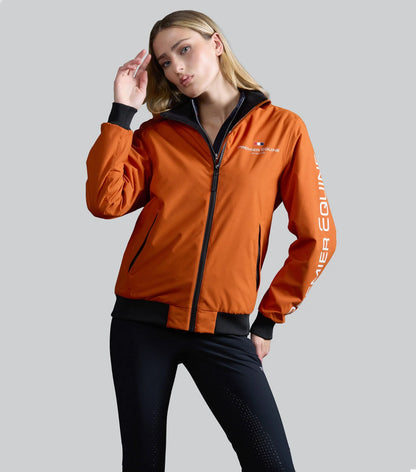 Premier Equine burnt orange women's riding jacket. Waterproof, stylish, and comfortable riding jacket for equestrian activities.